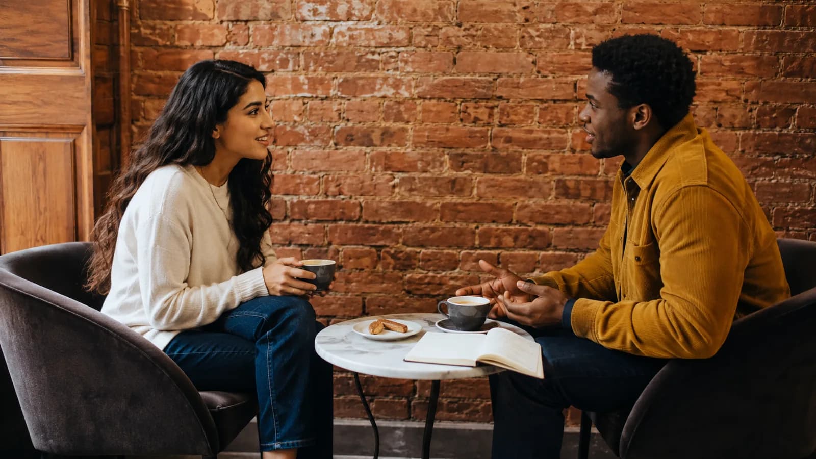 Two colleagues having a conversation over coffee